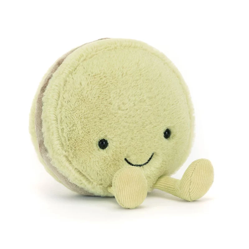 Front view of the Jellycat Amuseable Max Macaron, featuring soft green fur, a stitched smile, and matching corduroy feet.