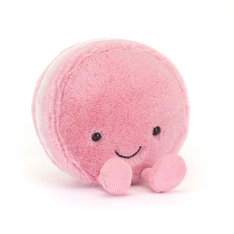 Front view of the Jellycat Amuseable Mia Macaron, featuring its soft strawberry fur, embroidered smile, and playful cord feet.