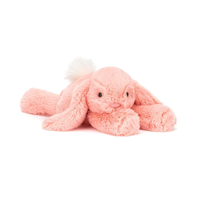 Front view of the Jellycat Smudge Apricot Bunny, showcasing its bright apricot fur, floppy lop ears, and fluffy cream bobtail.