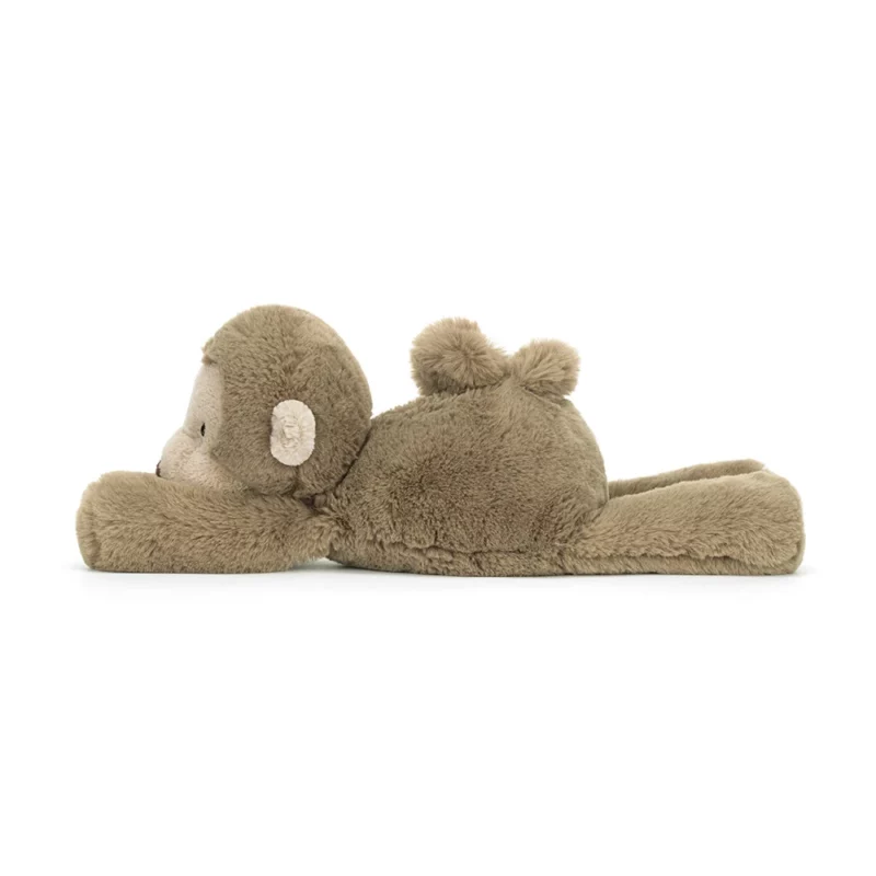 Side view of the medium Jellycat Smudge Monkey, showcasing its floppy posture and cute, curly tail.