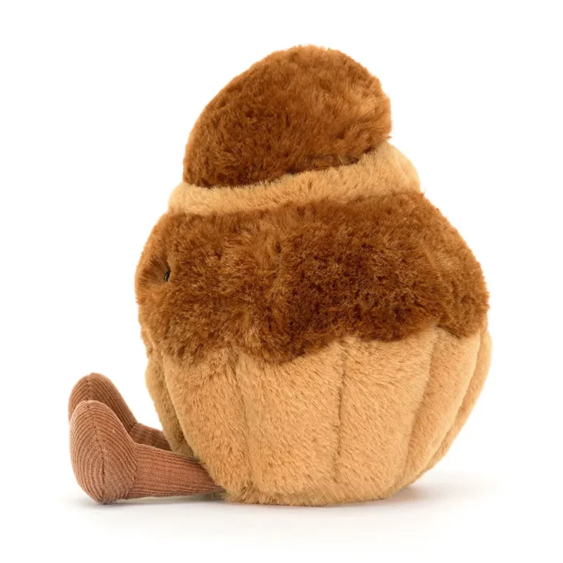 Side view of the Jellycat Amuseable Brigitte Brioche, highlighting its rounded shape, fluffy top, and soft textured fur.