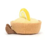 Side view of the Jellycat Amuseable Collette Tarte Au Citron, highlighting its textured pastry crust, lemon slice decoration, and fine cord legs.