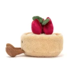 Side view of the Jellycat Amuseable Fleurette Tarte Aux Fraises, highlighting its fluffy texture, brown corduroy legs, and stacked strawberry decoration.