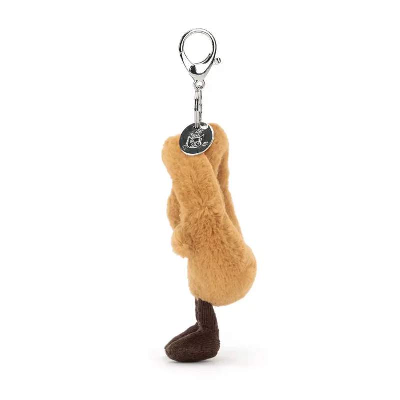 Side view of the Jellycat Amuseable Pretzel Bag Charm, highlighting the fluffy, looped shape of the pretzel.