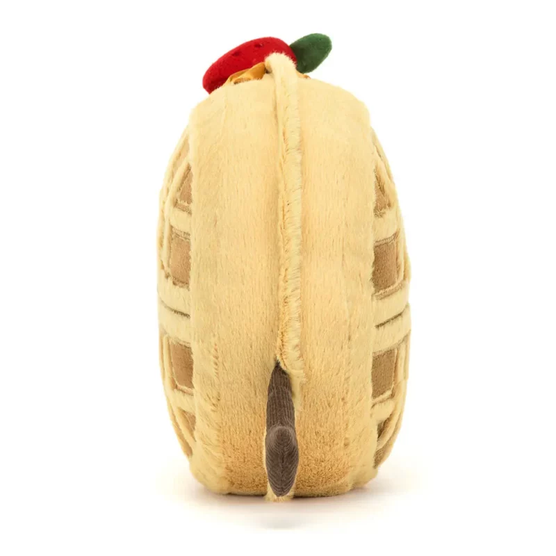 Side view of the Jellycat Amuseable Rene Waffle, highlighting its round plush body, embroidered waffle pattern, and extended fine cord arms.