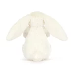 Rear view of the Jellycat Bashful Bunny With Present, showcasing its soft cream fur, floppy ears, and fluffy tail.