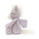 Side view of the original sized Jellycat Bashful Pegasus, highlighting its plush lavender fur, cream mane, and suede-textured wings.