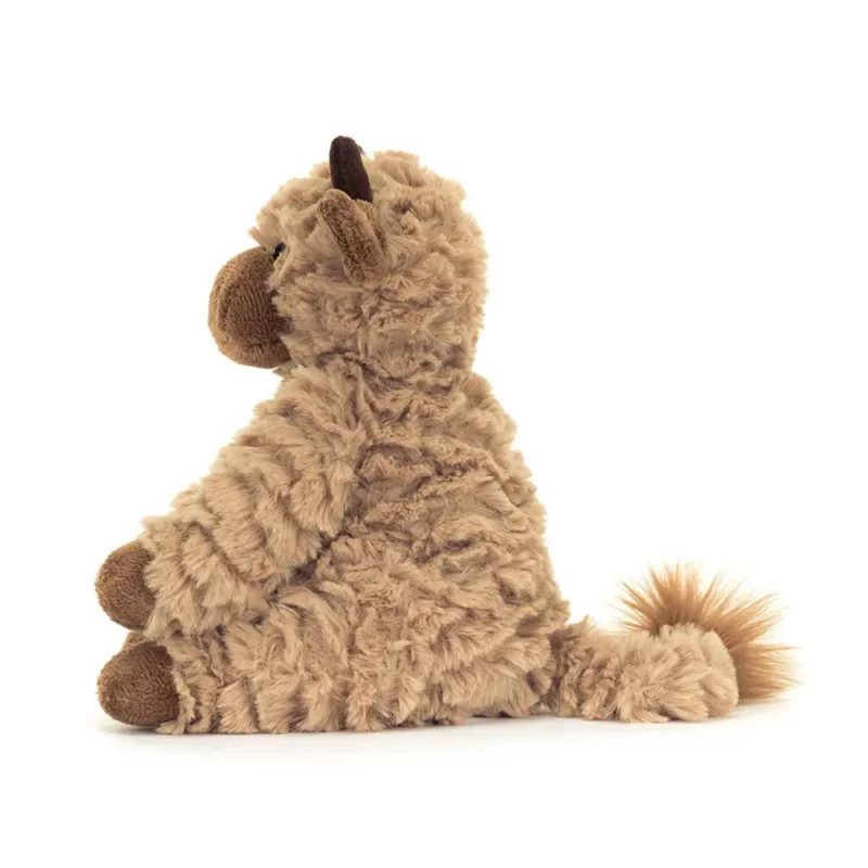 Side view of the Jellycat Fuddles Calf, highlighting its fluffy tail, curved horns, and huggable design.