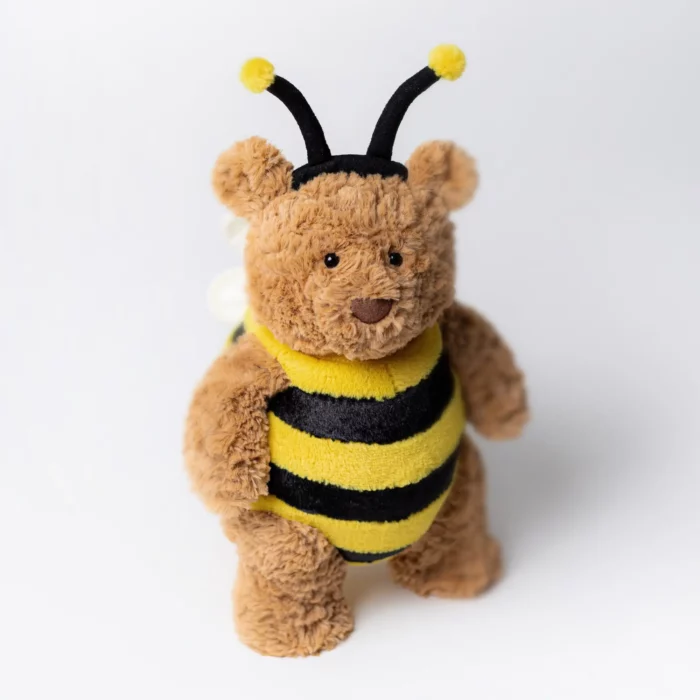 Detail view of Jellycat Bartholomew Bear 'Bumblebee' standing upright, showcasing his fuzzy brown fur and bee costume.