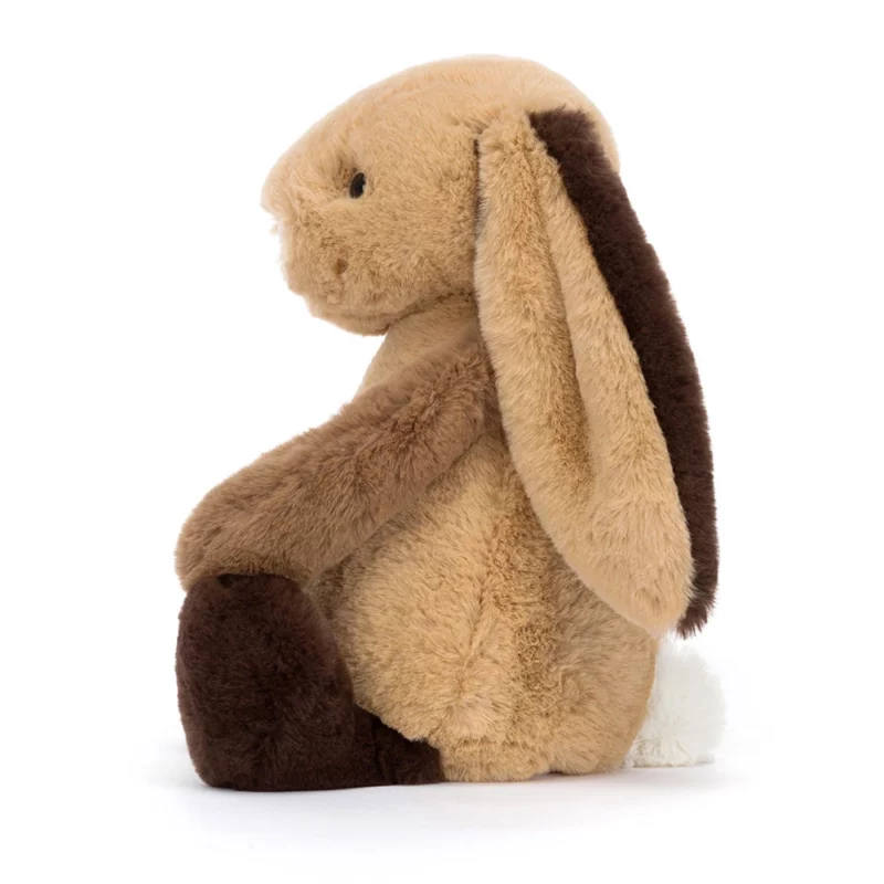 Side view of the Jellycat Bashful Patchwork Brown Bunny, showing its soft brown fur and fluffy white tail.