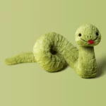 Detail shot of Jellycat Stevie Snake, showing the soft sage green plush, coiled body, embroidered details, and playful red tongue.