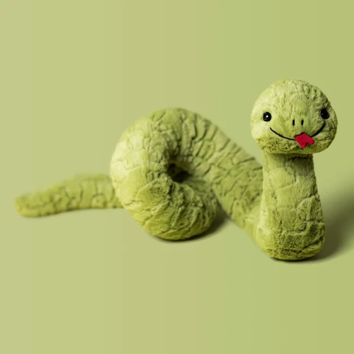 Detail shot of Jellycat Stevie Snake, showing the soft sage green plush, coiled body, embroidered details, and playful red tongue.