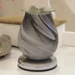 Grey Swirl Oval Aroma Electric Wax Melt Burner displayed on a white surface, highlighting its elegant grey swirl glass design with a modern, unlit appearance, perfect for contemporary décor.