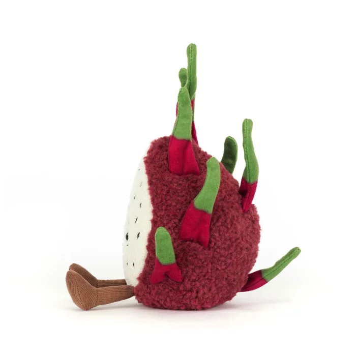 Side view of the Jellycat Amuseable Dragon Fruit highlighting her textured fuchsia body and vibrant green tufts.