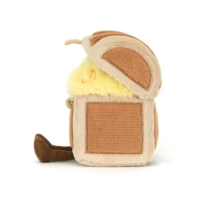 Side view of the Jellycat Amuseable Treasure Chest showing the lifted lid, soft panel details, and fuzzy yellow treasure inside.