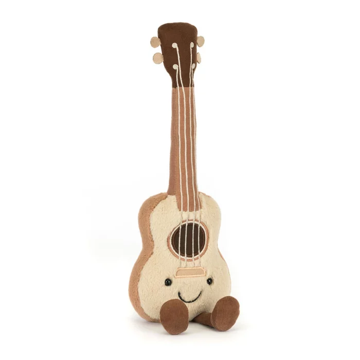 Front view of the Jellycat Amuseable Ukulele showing its cheerful face, cream front, and soft strings.