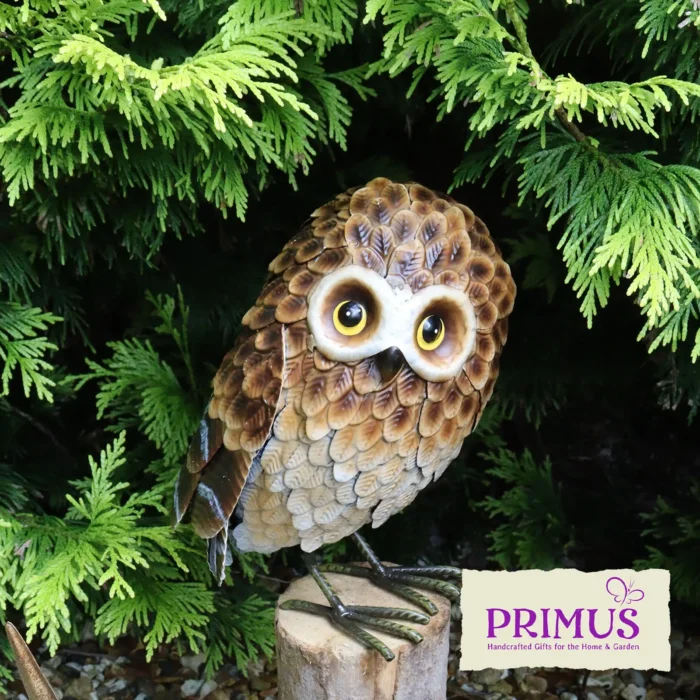 Owl Metal Garden Ornament perched on a tree branch surrounded by green foliage.