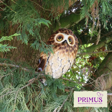 Owl Metal Garden Ornament perched in a tree surrounded by green foliage.