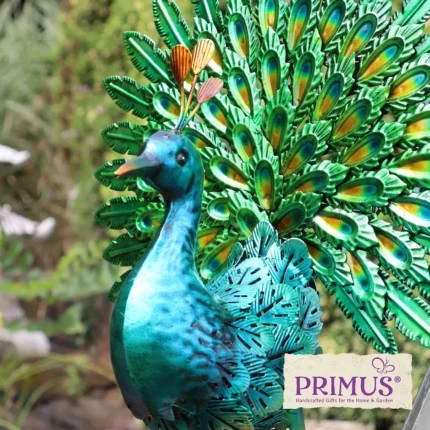 Peacock Metal Garden Ornament displayed in a garden setting with detailed green tail and metallic blue finish.