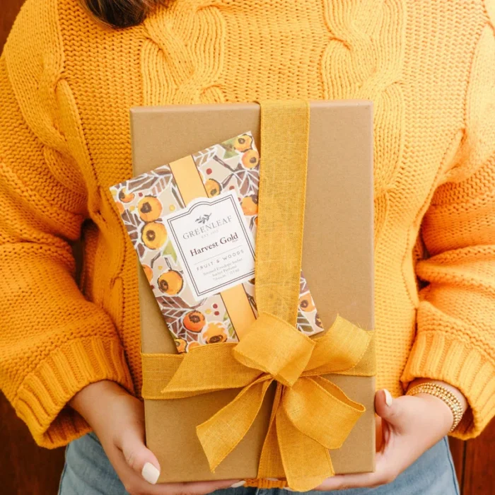 Greenleaf Harvest Gold Scented Sachet displayed with a wrapped gift and yellow ribbon.