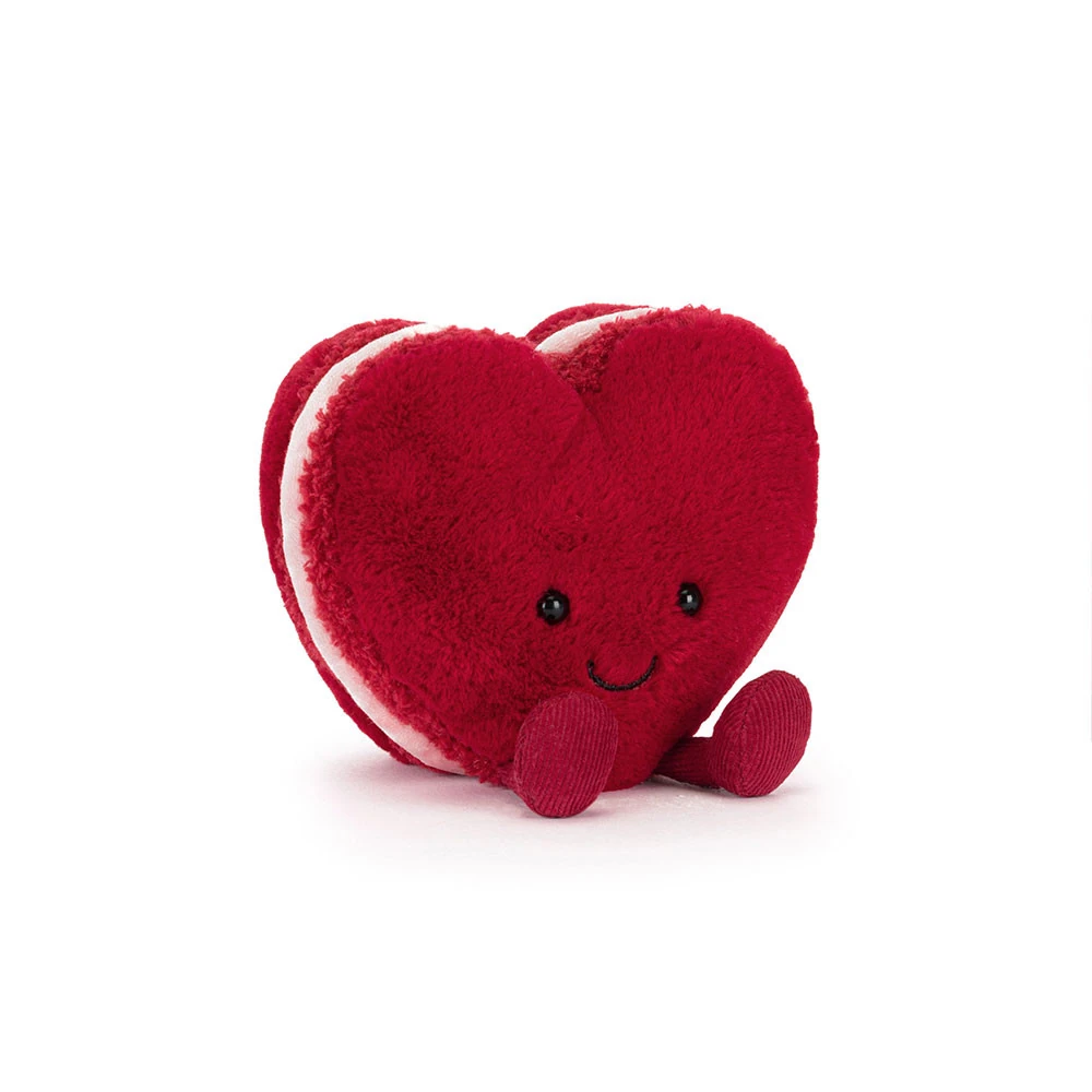 jellycat-amuseable-arlette-heart-macaron-front Front view of Jellycat Amuseable Arlette Heart Macaron, featuring plush red heart-shaped layers, corduroy legs, and a stitched smile.