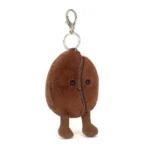 Front view of Jellycat Amuseable Coffee Bean Bag Charm, featuring a soft plush coffee bean with a stitched smile and cordy brown legs.