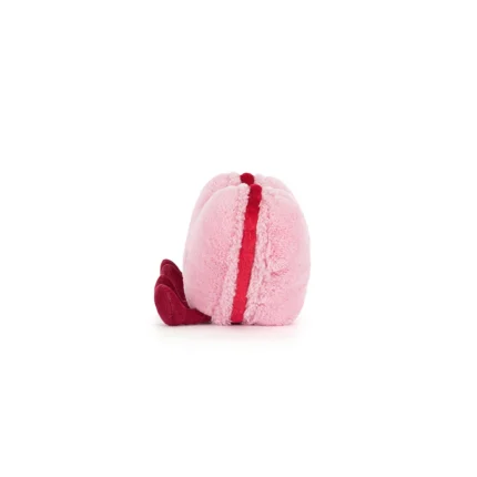 Side view of Jellycat Amuseable Colette Heart Macaron, revealing its soft sandwich-style shape with red filling.