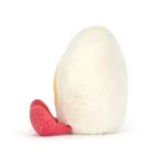Side view of Jellycat Amuseable Heart Boiled Egg, highlighting its fluffy white heart-shaped body and rounded profile.