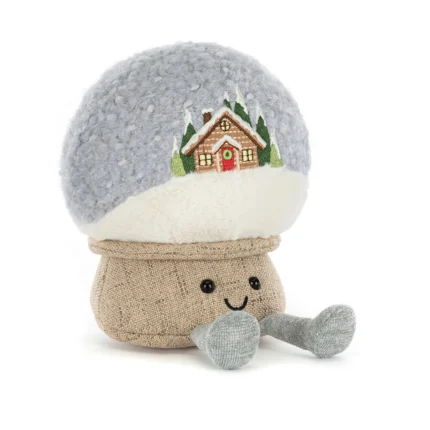 Front view of Jellycat Amuseable Snow Globe, showing a smiling beige base and soft dome with embroidered cabin and trees.