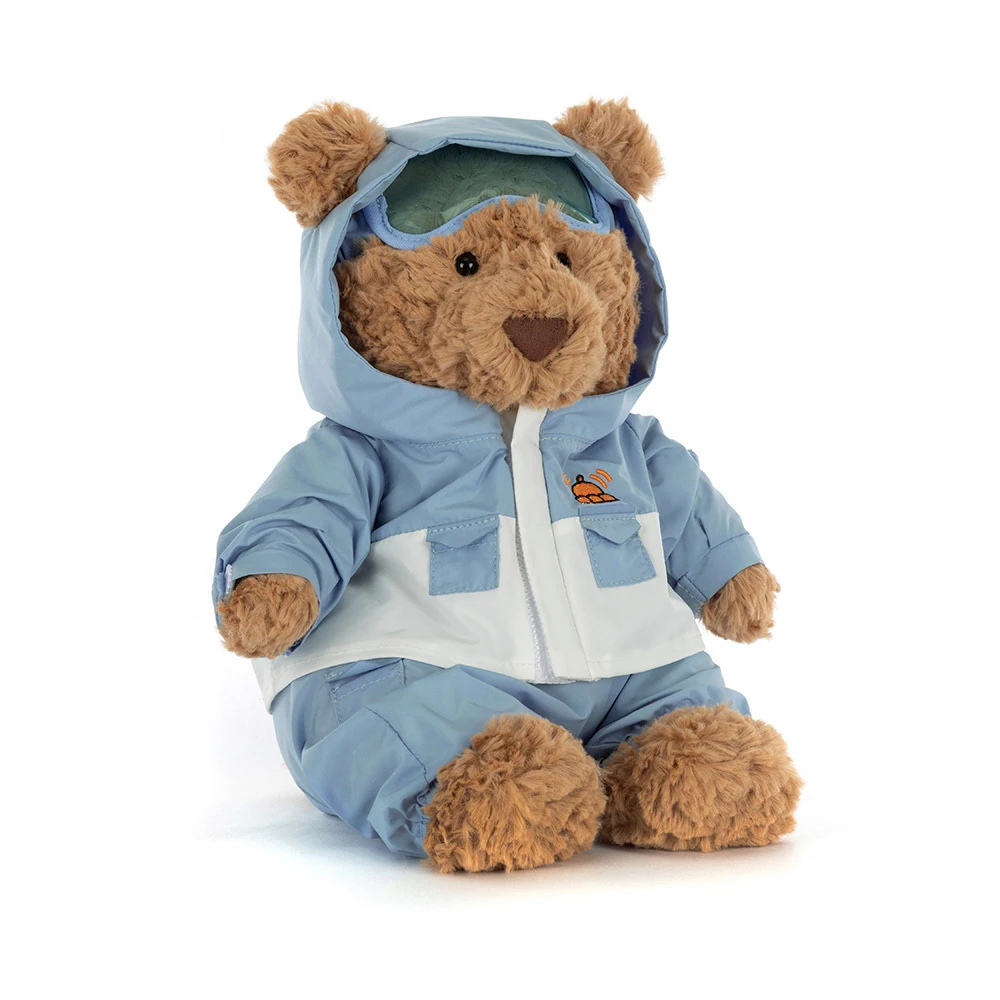 jellycat-bartholomew-bear-snow-suit-front Front view of Jellycat Bartholomew Bear Snow Suit, showing the cuddly bear wearing a blue and white snowsuit with hood and goggles.
