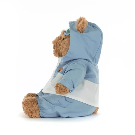 Side view of Jellycat Bartholomew Bear Snow Suit, highlighting the padded snowsuit, hood detail, and seated profile.