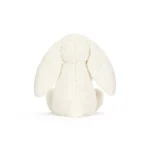 Rear view of Jellycat Bashful Cream Bunny with Rose, showing her round fluffy tail and draping ears from behind.