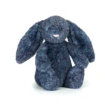 Front view of Jellycat Bashful Hopscone Luxe Bunny, with mottled blue and purple fur, a pink nose, and floppy ears.