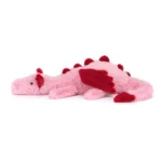 Side view of Jellycat Heart Dragon, highlighting its spiky red spine, curled tail, and soft velvety body.