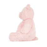 Side view of the large Jellycat Leola Bear, showing her plump profile, upright ears, and pastel pink textured fur.