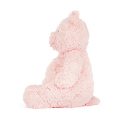Side view of the large Jellycat Leola Bear, showing her plump profile, upright ears, and pastel pink textured fur.