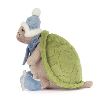 Side view of Jellycat Timmy Turtle 'Skating', highlighting his green shell, scarf, and fluffy pompom hat.