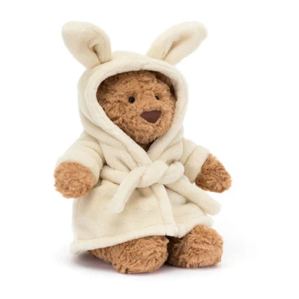 Front view of Jellycat Bartholomew Bear in cream bathrobe with hood and bunny ears.