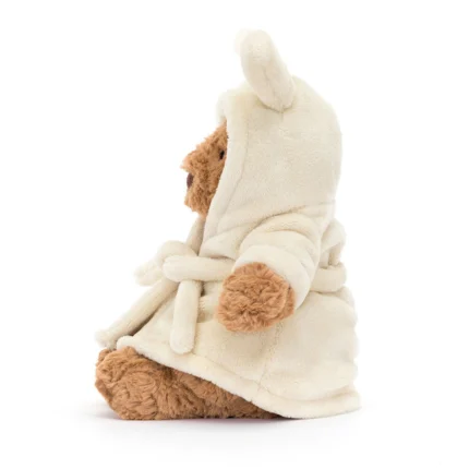 Side view of Jellycat Bartholomew Bear in cream bathrobe showing robe belt and profile.