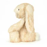 Side view of Jellycat Bashful Springlowe Luxe Bunny showing long floppy ears, cream tail, and textured fur.