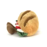 Side view of Jellycat Amuseable Caprese Baguette showing soft golden bread, layered tomato and mozzarella, and brown cordy legs.