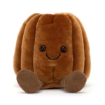 Alternative front view of Jellycat Amuseable Carole Canelé featuring smiling face, glossy eyes and cordy legs.