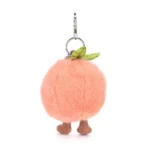 Rear view of Jellycat Amuseable Peach Bag Charm highlighting the soft velvety blush plush and small green leaf detail.