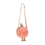 Front view of Jellycat Amuseable Peach Shoulder Bag with soft peach fur, stitched smile, brown cord legs and adjustable strap.