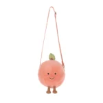 Alternative front view of Jellycat Amuseable Peach Shoulder Bag featuring stitched smile, green leaf and adjustable strap.