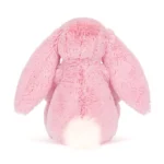 Rear view of Jellycat Blossom Blushkin Luxe Bunny Original highlighting soft pink plush, long ears and fluffy cream tail.