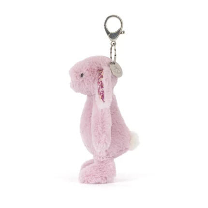 Side view of Jellycat Blossom Thistlepop Bunny Bag Charm showing plush pastel purple fur, floppy floral ears and attached silver clip.