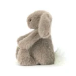 Side view of Jellycat Fawn Flufflet Bunny showing plush fawn brown fur, long floppy ear and fluffy cream tail.