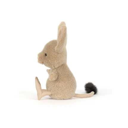 Side view of Jellycat Jerboa showing plush sandy fur, tall upright ear and long tail with black tip.