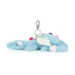 Side view of Jellycat Sky Dragon Bag Charm showing plush baby blue fur, white wings, rainbow back spikes and attached silver clip.
